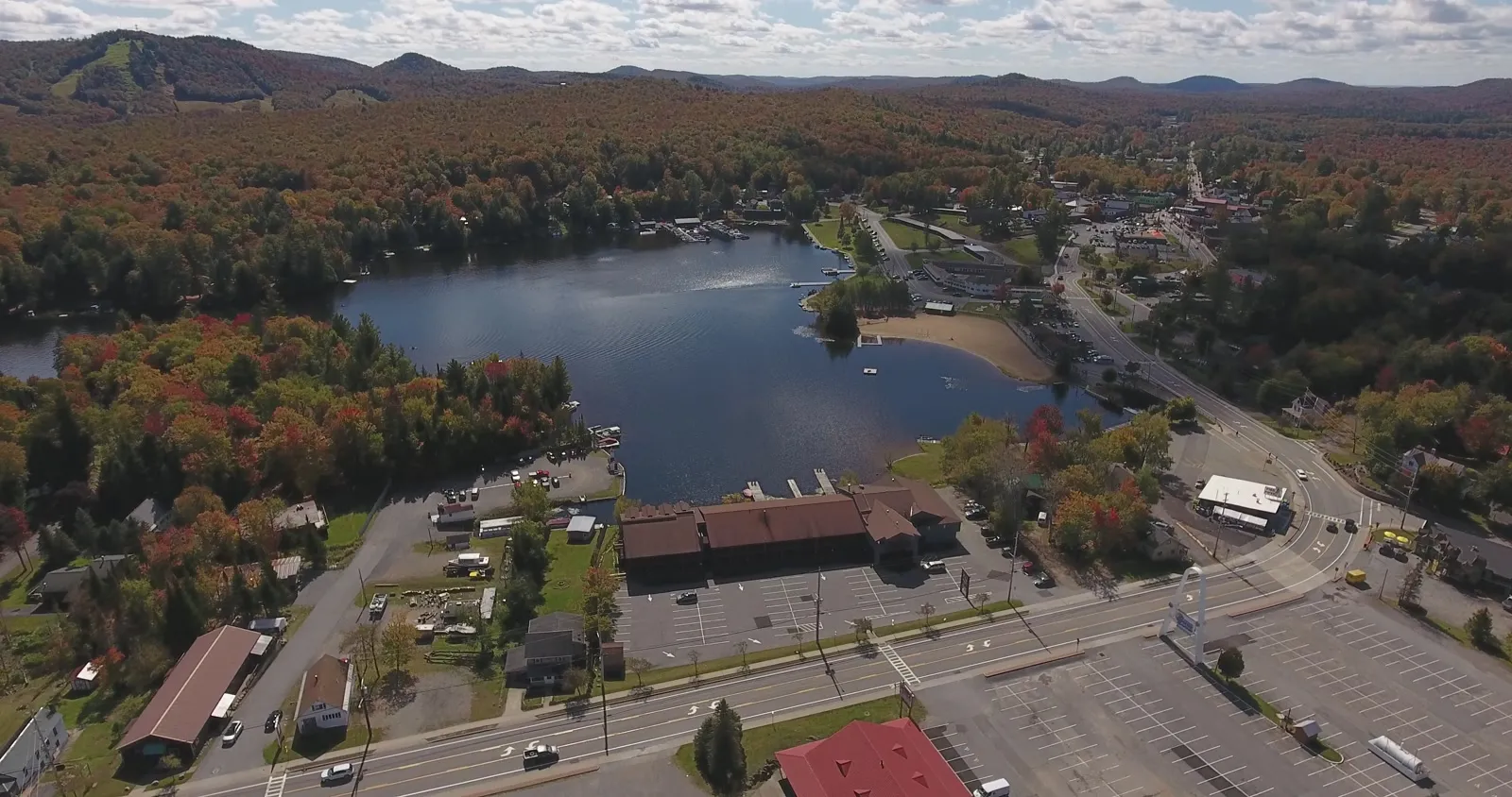 Old Forge village and Old Forge Pond from the air, fall color on the hills
