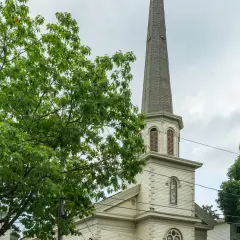 The Kirkland Art Center's white former church building and its tall spire, Clinton