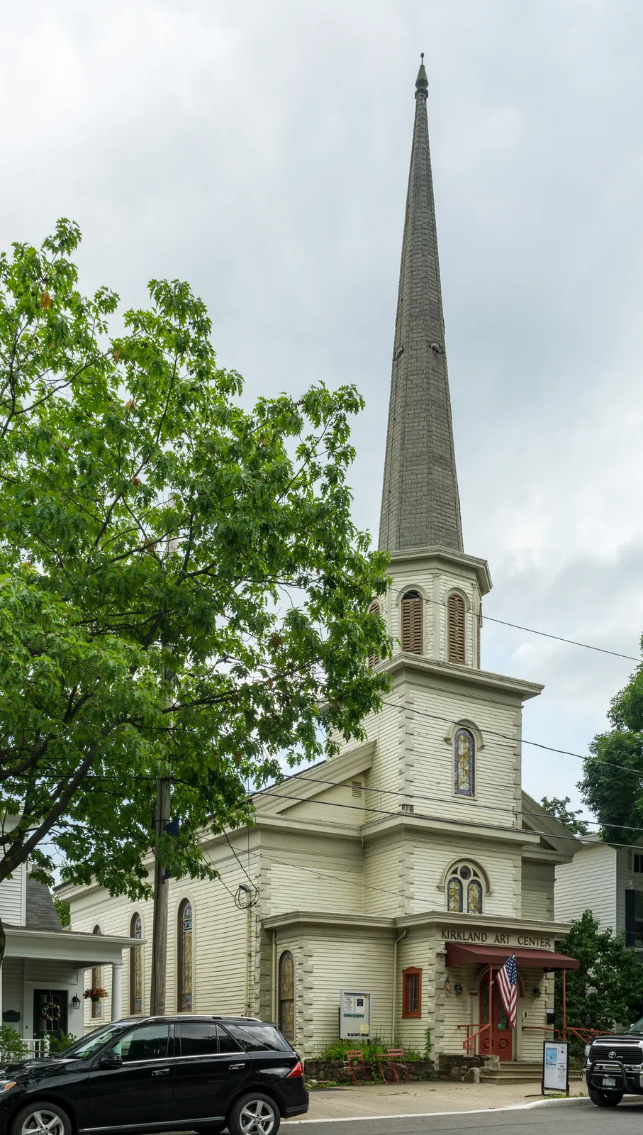 The Kirkland Art Center's white former church building and its tall spire, Clinton